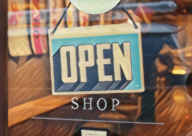 open sign hanging on door of shop door