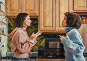 two women standing in the kitchen having an argument