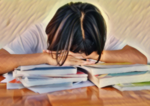 child head on books frustrated